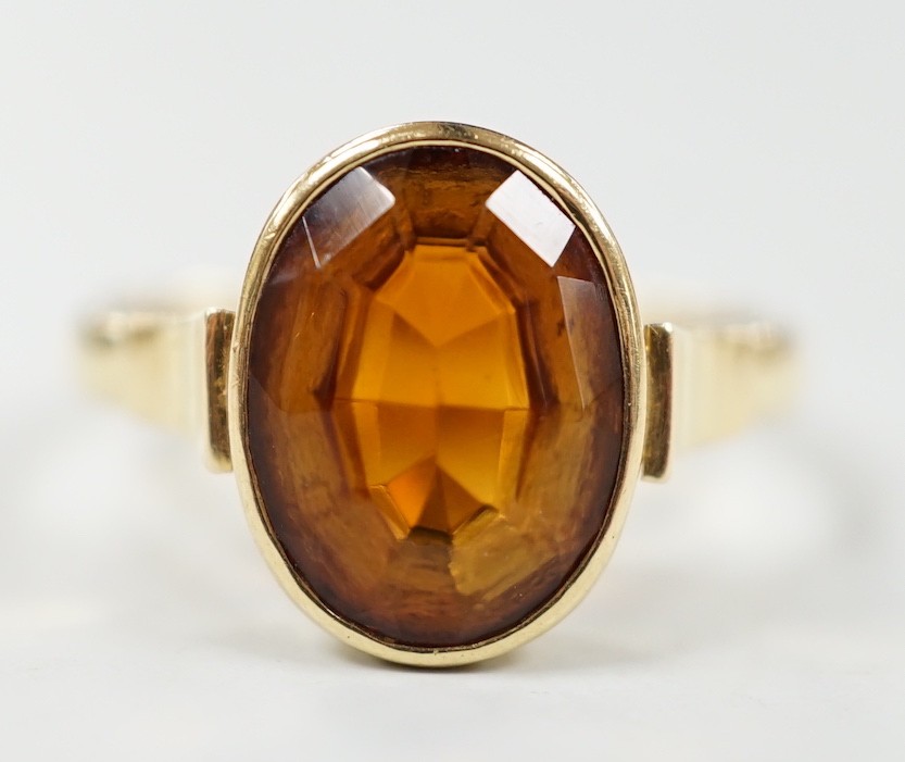 A George V 750 yellow metal and oval cut citrine set ring, size Q, gross weight 5.6 grams.